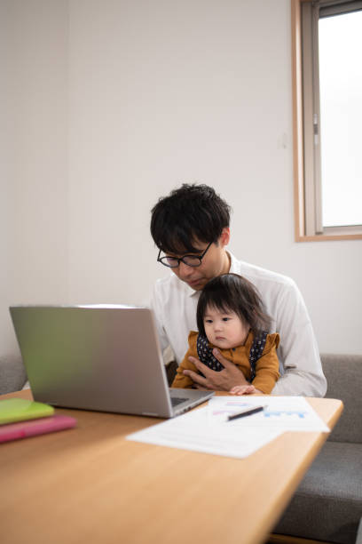 istock Father working with baby at home 1133634846