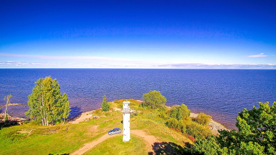 A tower in the edge of the cliff of the lake. Fronting the tower is the Nina church in Peipsi Estonia