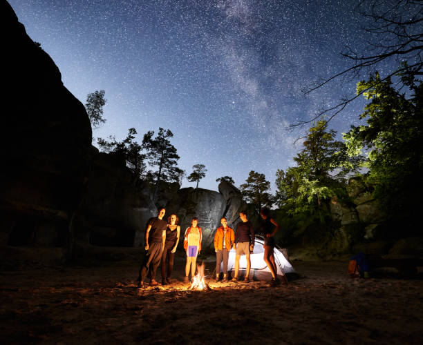 istock Friends hikers resting beside camp, campfire, tent at night 1133636041