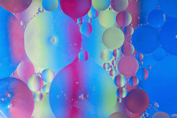 istock Oil drops in water macro with a colourful background 1133636323