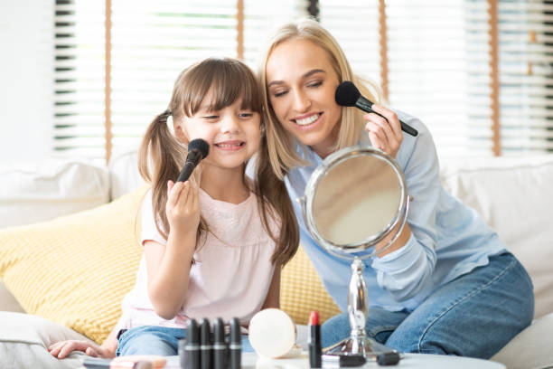 istock Mother and daughter applying cosmetic. 1133637104