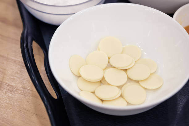 istock White chocolate chips in a bowl for melting, preparing ingredients to make a cake. 1133637863