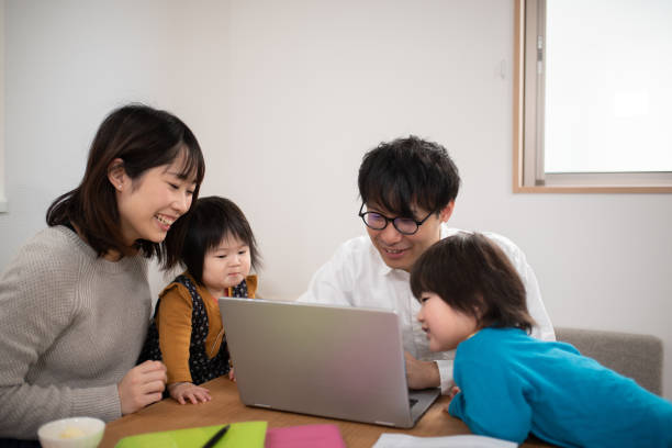istock Family looking at laptop at home 1133637996