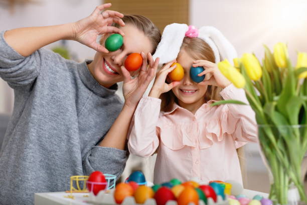 istock Mother and daughter painting Easter eggs 1133638941