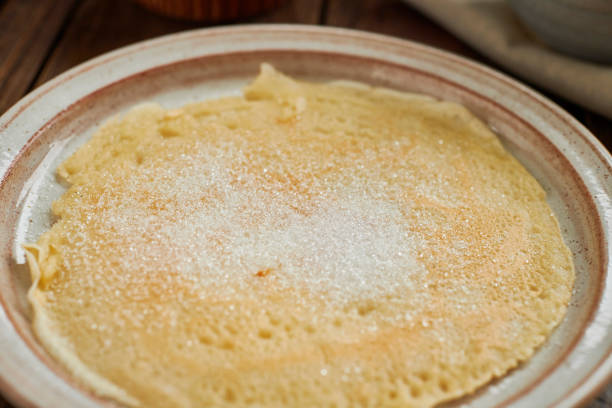 istock Pancake on a rustic plate topped with sugar. 1133639960
