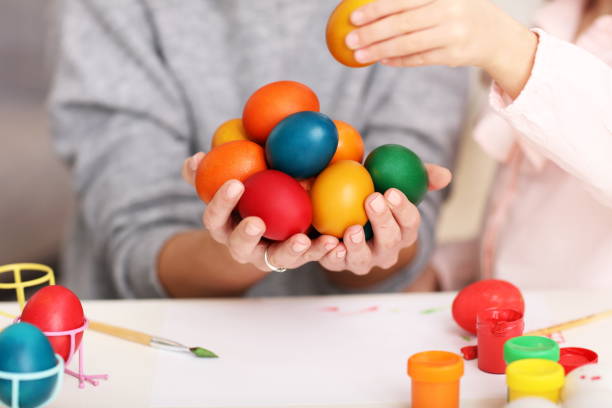 istock Mother and daughter painting Easter eggs 1133640063