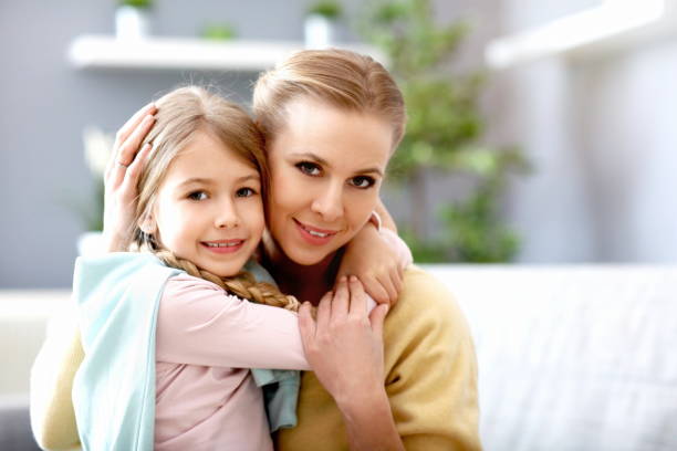 istock Beautiful mom and her daughter having fun at home 1133640091