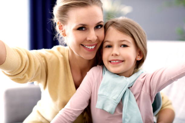 istock Beautiful mom and her daughter having fun at home 1133640100