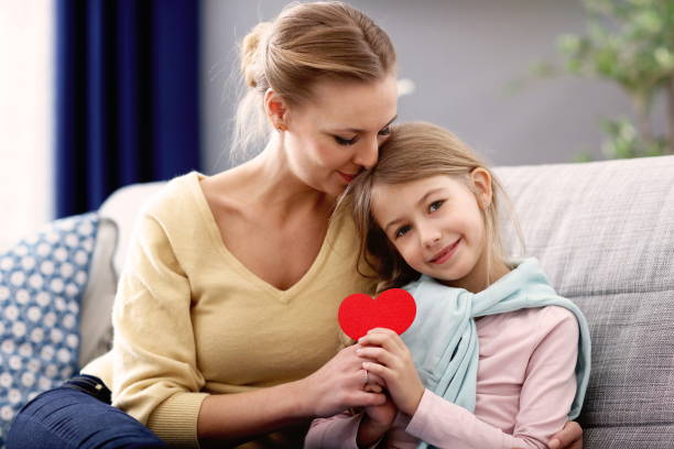 istock Beautiful mom and her daughter having fun at home 1133640110