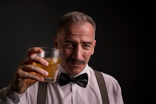 man, drink, whiskey, liquor, person, lifestyle, handsome, portrait, modern, stylish, strong, toast, caucasian, attractive, one, beard, alcohol, glass, young, elegance, trendy, guy, macho, closeup, elegant, face, suit, expression, luxury, cool, studio, look, smart, white, black