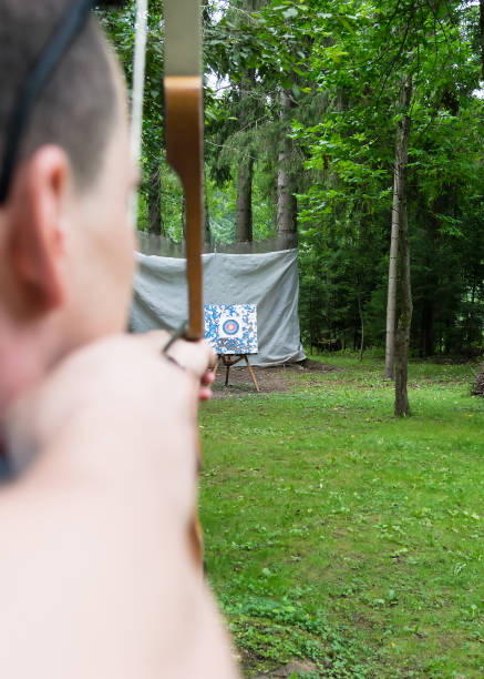 istock archery in the woods on the target rear view 1133641662