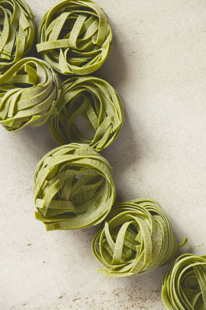 istock Raw dry spinach pasta tagliatelle on the grey table 1133641845