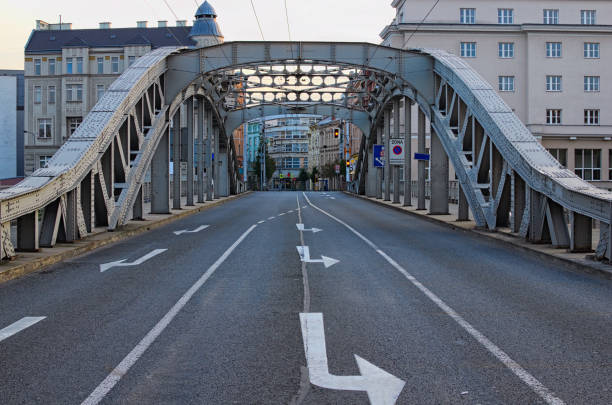 Milos Sykora bridge in Ostrava. Steel arch bridge over the Ostravice river. Technical monument and sightseeing. Summer evening view. Ostrava, Czech Republic.