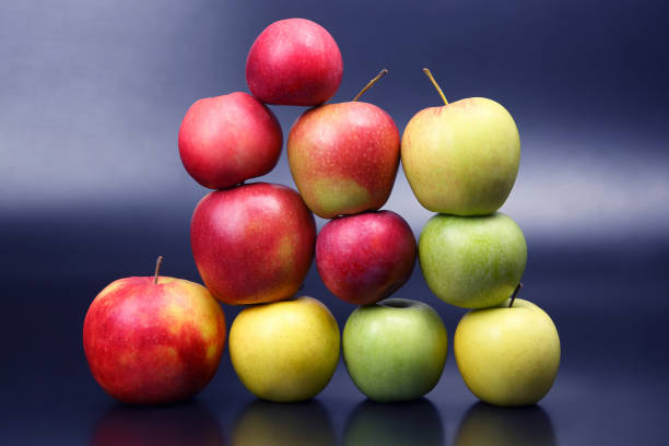 istock Wall of fresh different apples on dark background 1133645619