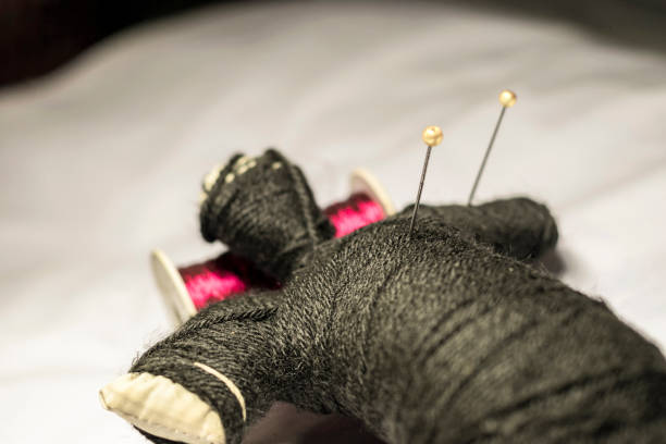 istock black magic doll sleeping and two needle dipped into it's chest 1133649035