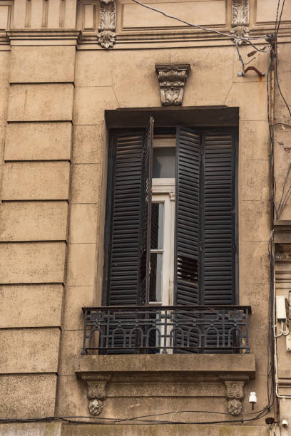 istock Old window with iron shutters and a balcony with bars 1133649178