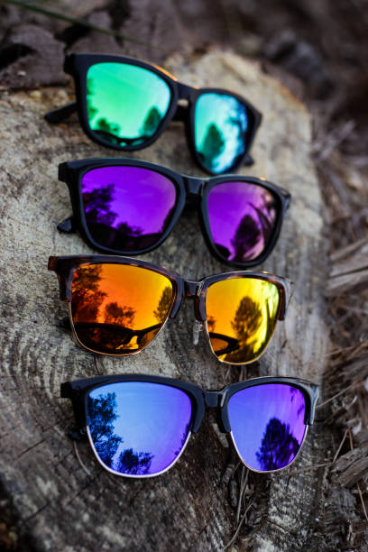 istock Unbranded colorful sunglasses on tree log 1133651639