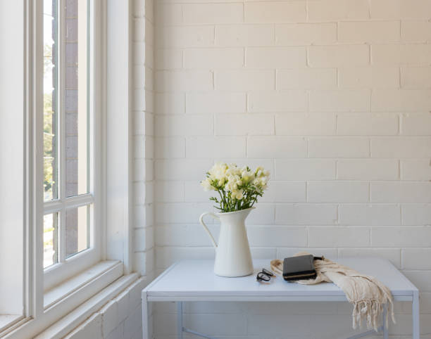 istock White freesias in jug on dressing table next to window 1133655275