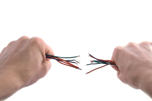 istock two hands tore the colored wires on white 1133655535