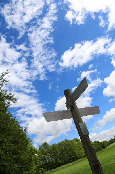 istock Blank signpost outdoors with forest and summer sky in the background 1133657094