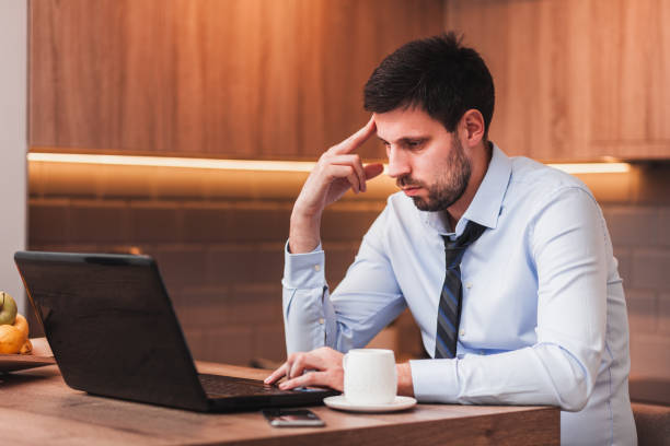 istock Young businessman working on laptop at home 1133657454