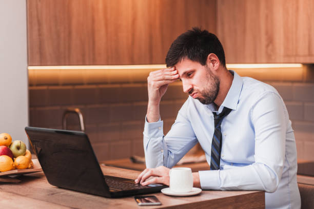 istock Young businessman working on laptop at home 1133657456