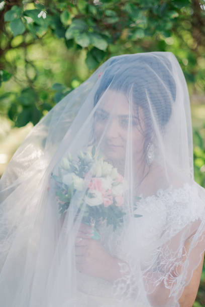 istock Very beautiful bride is holding a bouquet 1133658063