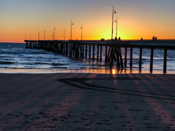 istock Sunset brightens the sky over the Pacific Ocean in Venice, CA 1133659222