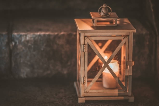 istock One lonely votive candle standing on tombstone and burning. 1133659895