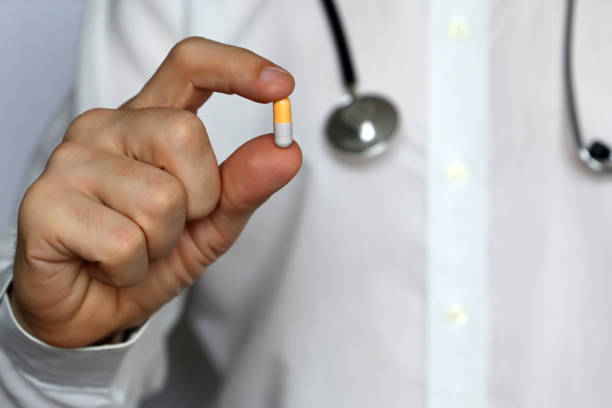 istock Doctor with pill, man giving medication in capsule 1133659973
