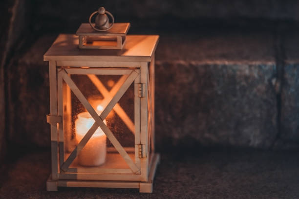 istock One lonely votive candle standing on tombstone and burning. 1133660070