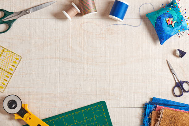 istock Frame of quilting accessories with space for text on cream-white wooden surface 1133664050