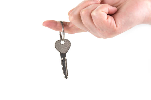 istock A key from a new house in a finger. 1133666118