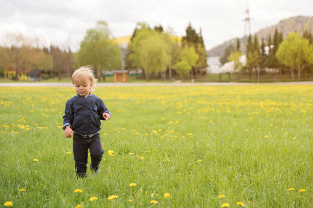 istock Happy child walking throw the grass and enjoying 1133667781