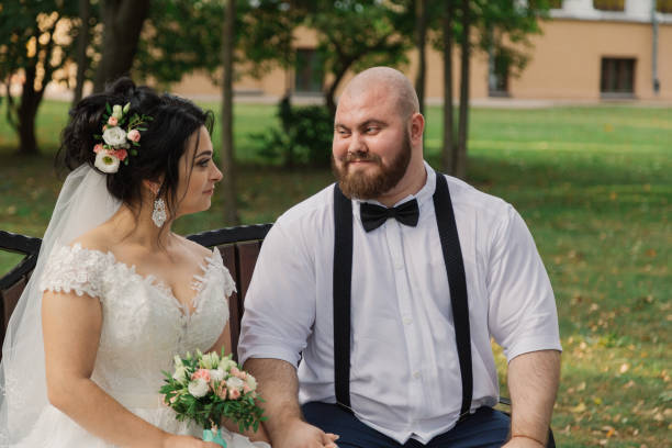 istock Newlyweds sit on a bench in the park 1133669285