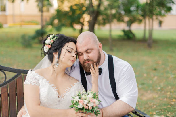 istock Newlyweds sit on a bench in the park 1133669608