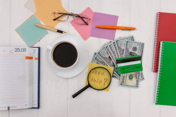 istock Dollars with credit card and magnifier on laptop keyboard 1133669864