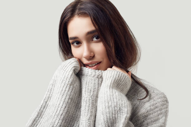 istock Beautiful brunette woman in sweater posing in studio 1133670832