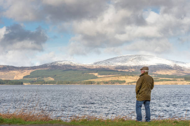istock Active senior man at the edge of a loch 1133671233