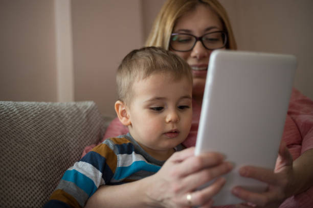 istock Mother and son with tablet at home. 1133671263