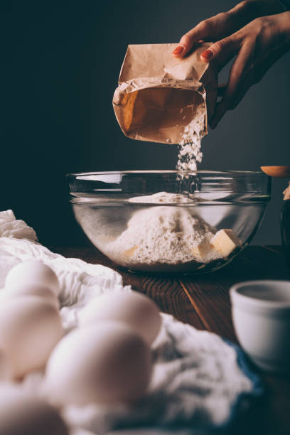 istock Woman's hands pouring flour into bowl 1133671405