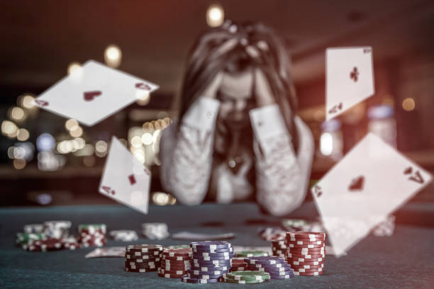 Upset woman in casino with falling cards Upset woman in casino with falling cards defeat photos stock pictures, royalty-free photos & images