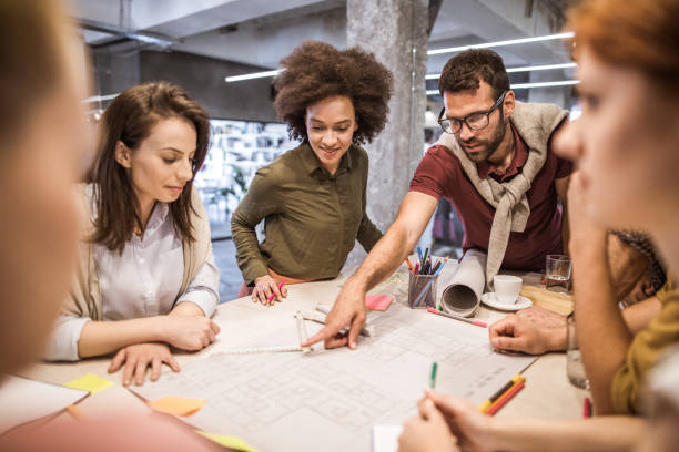 istock Group of young creative people working at casual office. 1133671700