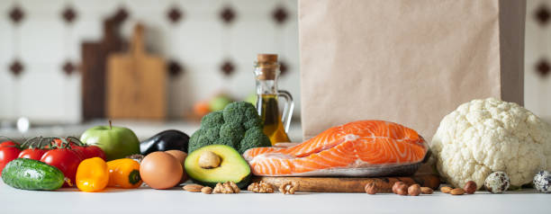 istock Fresh vegetables, fruits, nuts and salmon steak. 1133672403