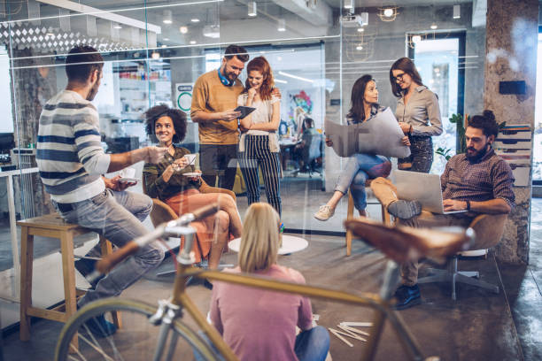 istock Happy multi-tasking freelance workers working at casual office 1133672491
