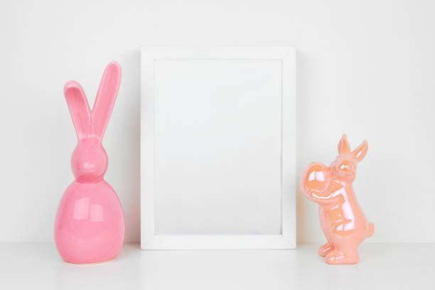istock Mock up white frame with modern pink Easter bunny decor on a shelf 1133673768
