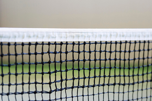 Net of tennis court on gray wall background