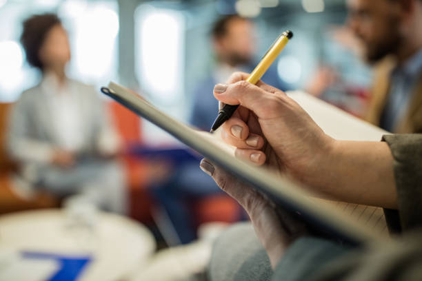 istock Close up of unrecognizable businessman taking notes on the paper. 1133674051