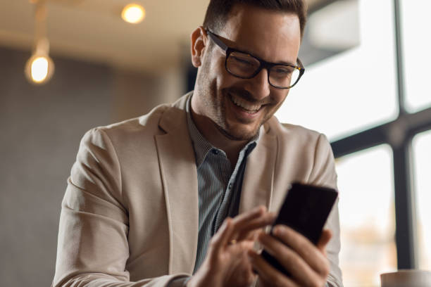 istock Happy businessman text messaging on cell phone 1133676981