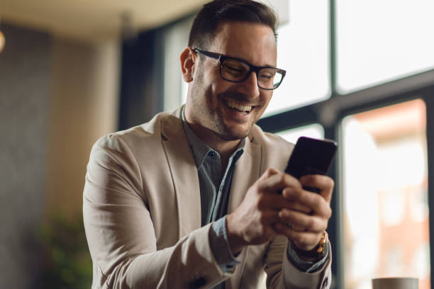 istock Happy businessman text messaging on cell phone 1133677505
